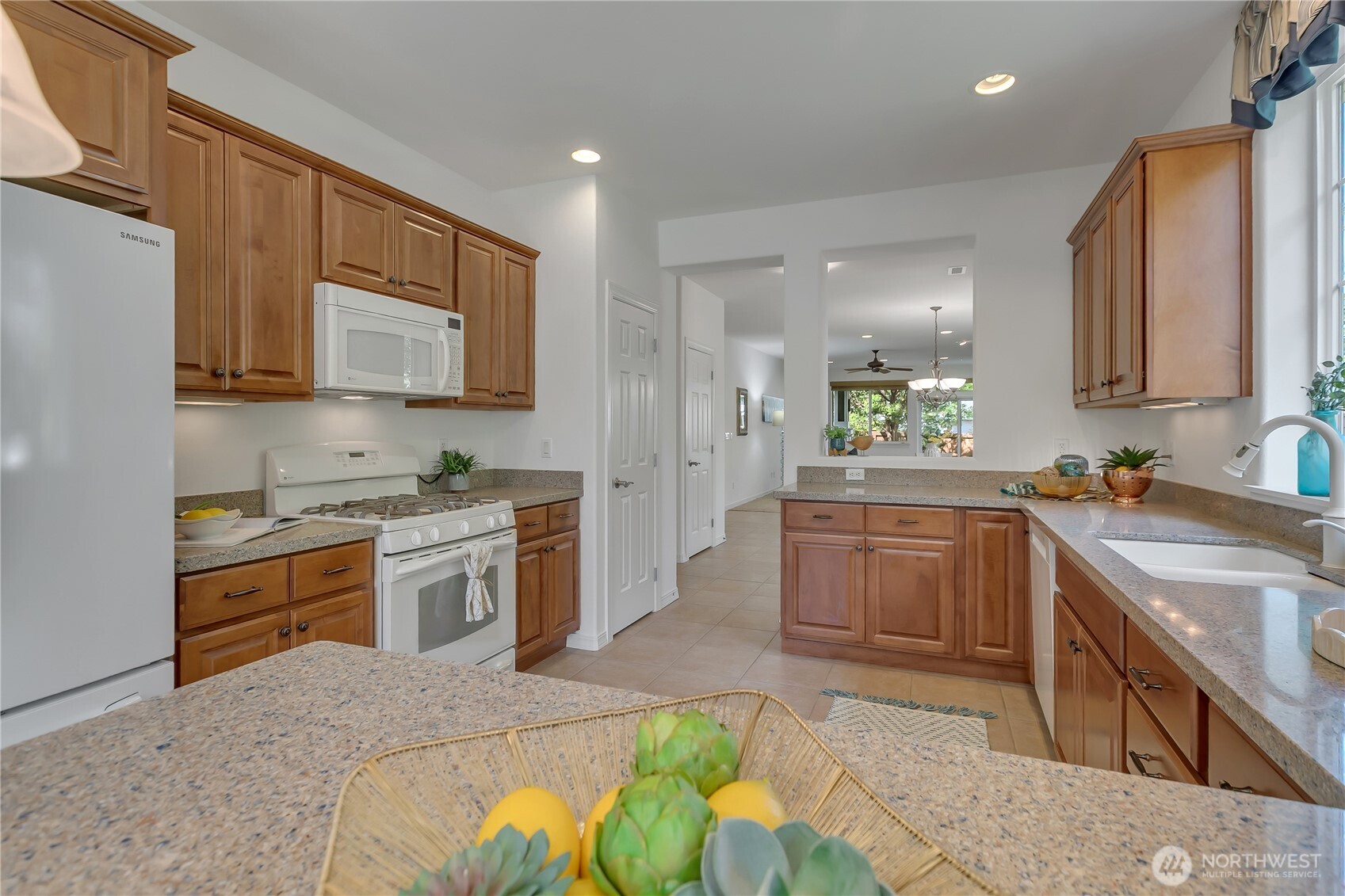 4961 Spokane Street Northeast Lacey, WA 98516 - Photo 10 of 38 a kitchen with stainless steel appliances granite countertop a sink stove and refrigerator