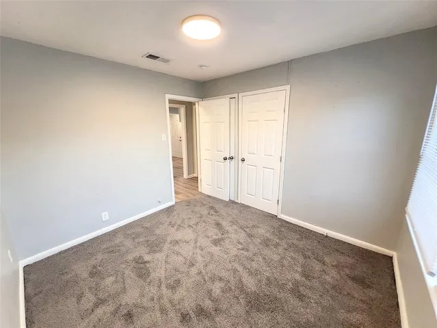 an empty room with a empty space and a window