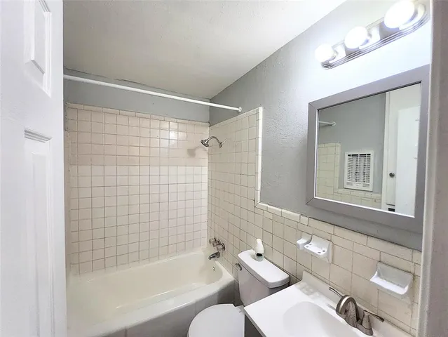 a bathroom with a bathtub and a sink