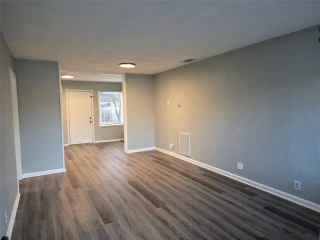 a view of an empty room and wooden floor