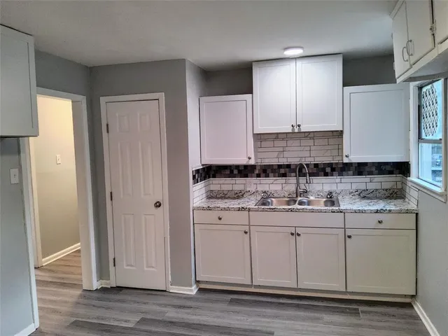 a bathroom with a granite countertop sink a mirror and a