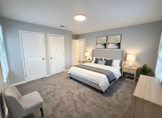 a bedroom with a bed and a couch