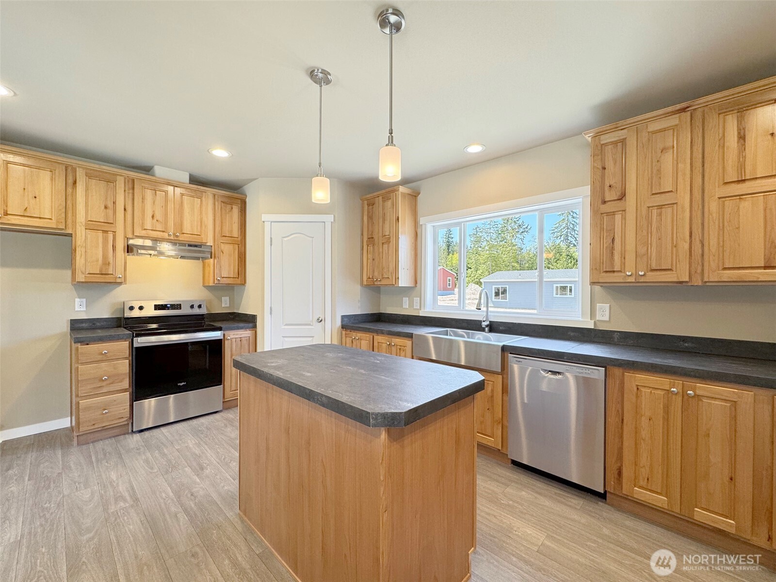 41 Butterfly Lane Pacific Beach, WA 98571 - Photo 12 of 37 a kitchen with stainless steel appliances granite countertop a sink a stove a kitchen island and a window