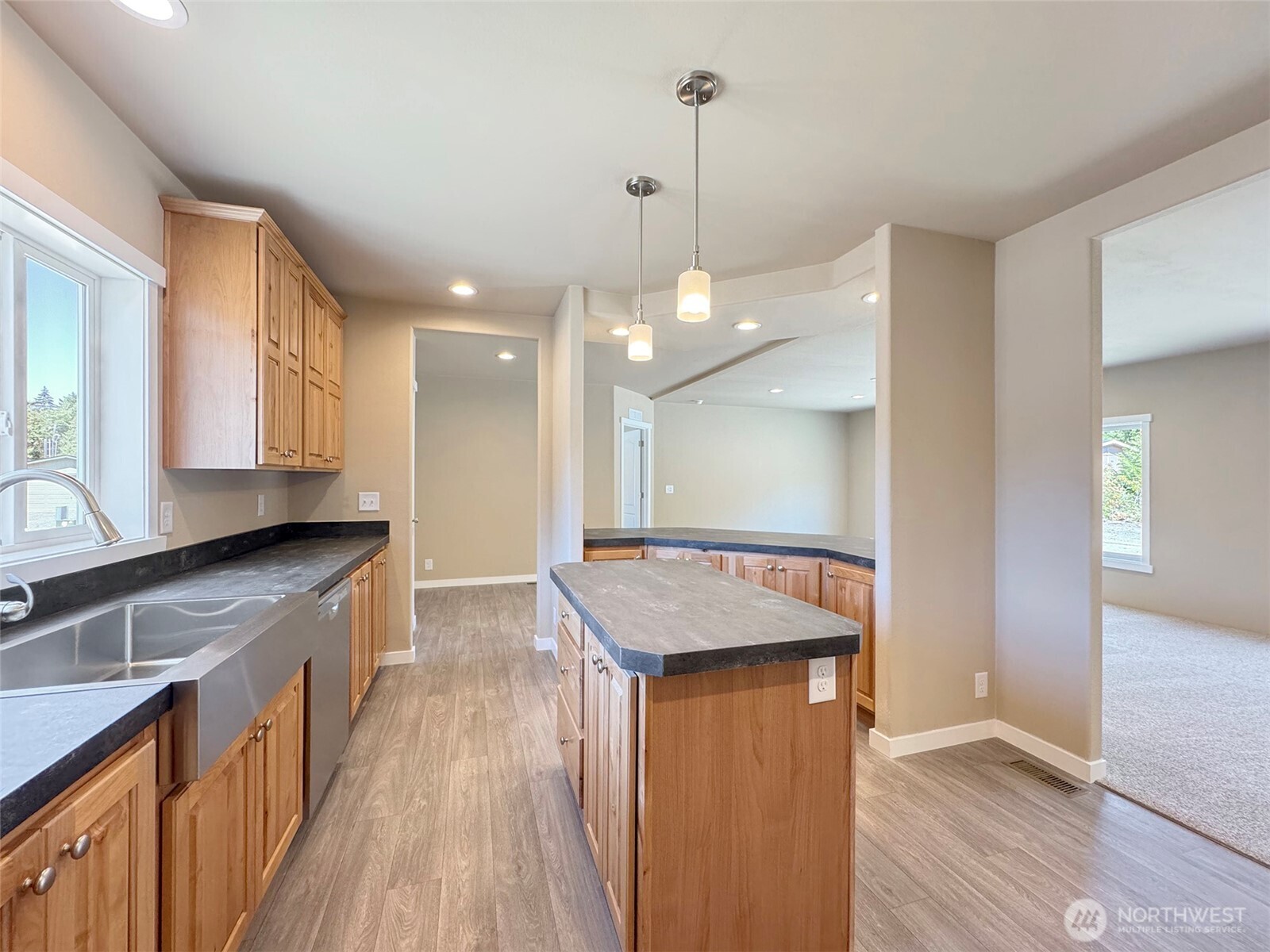 41 Butterfly Lane Pacific Beach, WA 98571 - Photo 16 of 37 a kitchen with stainless steel appliances granite countertop hardwood floor sink stove and wooden cabinets