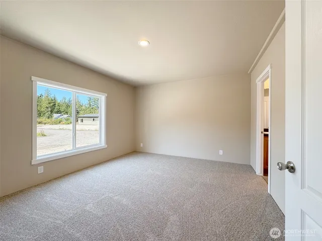 an empty room with closet and a window