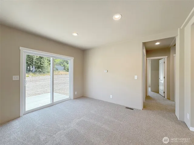 an empty room with windows and city view