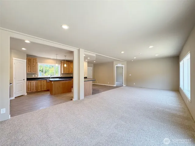 a view of an empty room with a kitchen