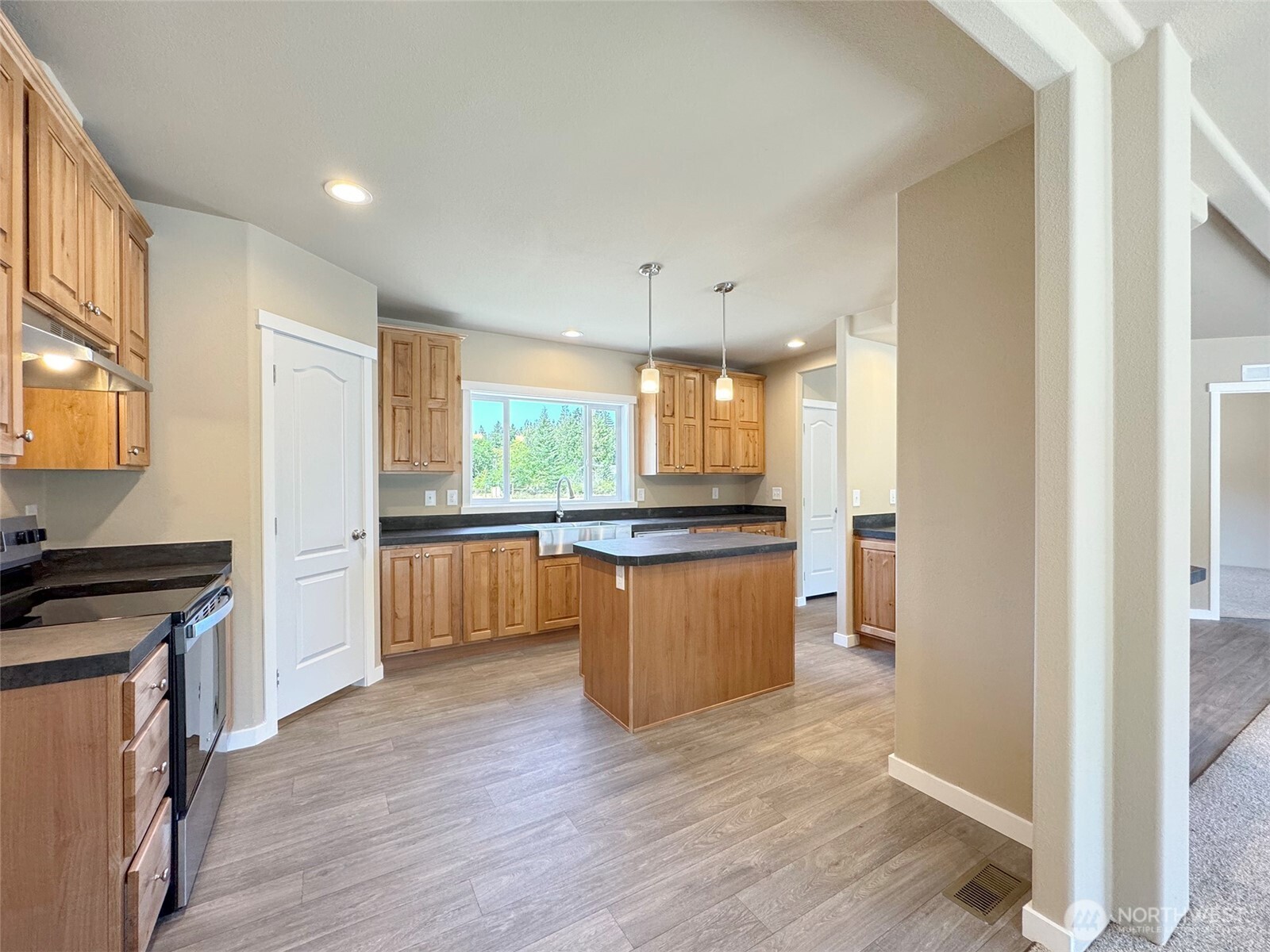 41 Butterfly Lane Pacific Beach, WA 98571 - Photo 10 of 37 a kitchen with stainless steel appliances granite countertop a refrigerator a sink dishwasher a stove and white countertops with wooden floor