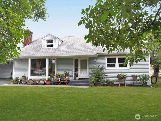 a front view of house with yard and outdoor seating