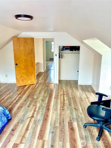 a view of a room with wooden floor and chair