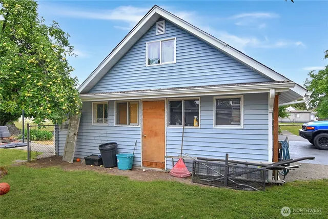a front view of house with a garden and patio
