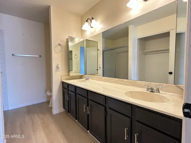 a bathroom with a double vanity sink and a mirror