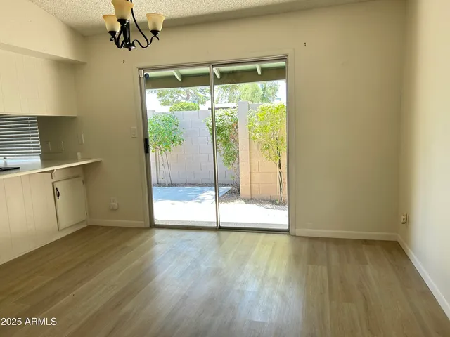 a view of a room with wooden floor and a window