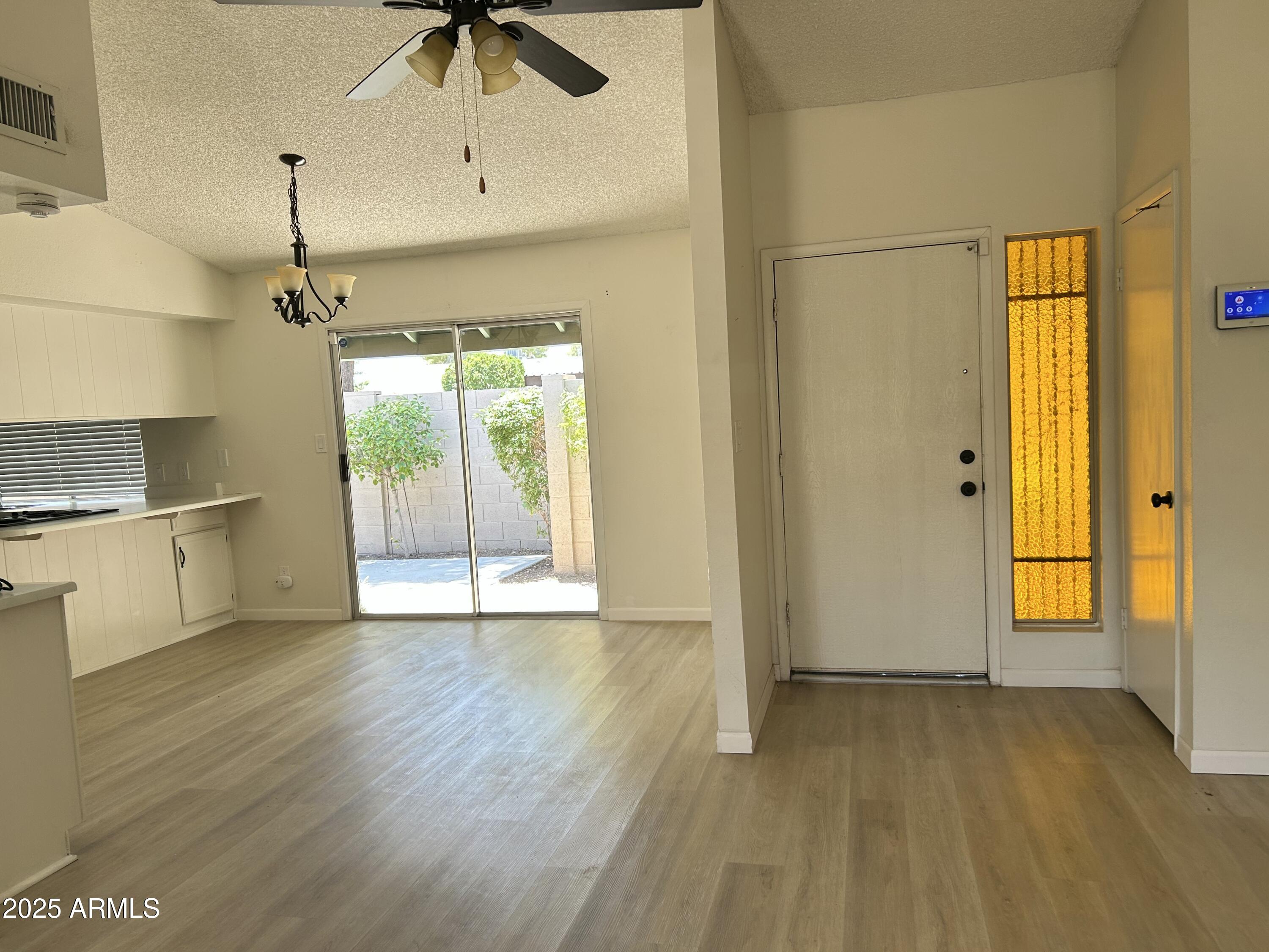 17838 North 45th Avenue Glendale, AZ 85308 - Photo 5 of 17 a view of an empty room with window and wooden floor
