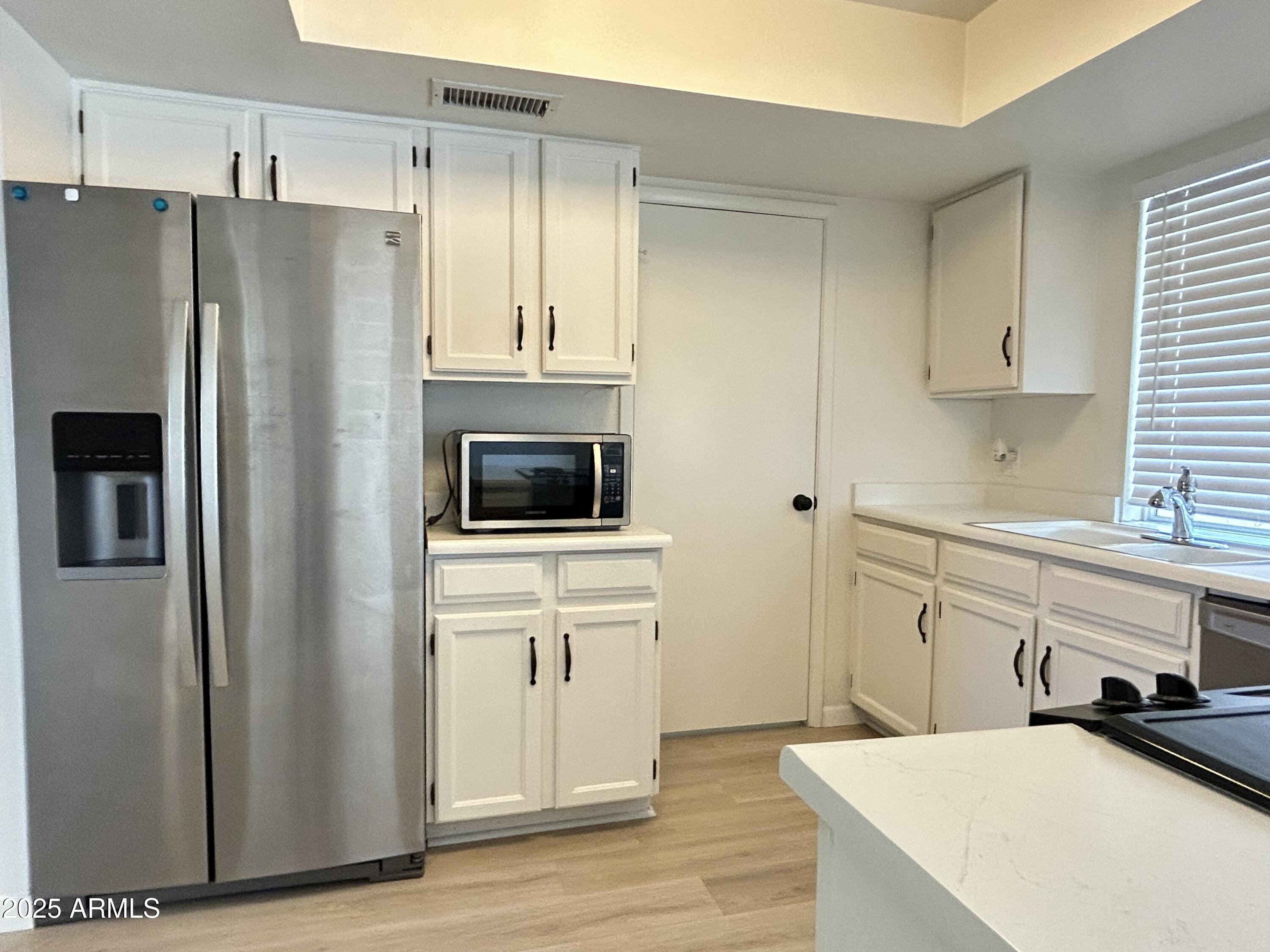 17838 North 45th Avenue Glendale, AZ 85308 - Photo 7 of 17 a kitchen with stainless steel appliances a refrigerator sink and cabinets