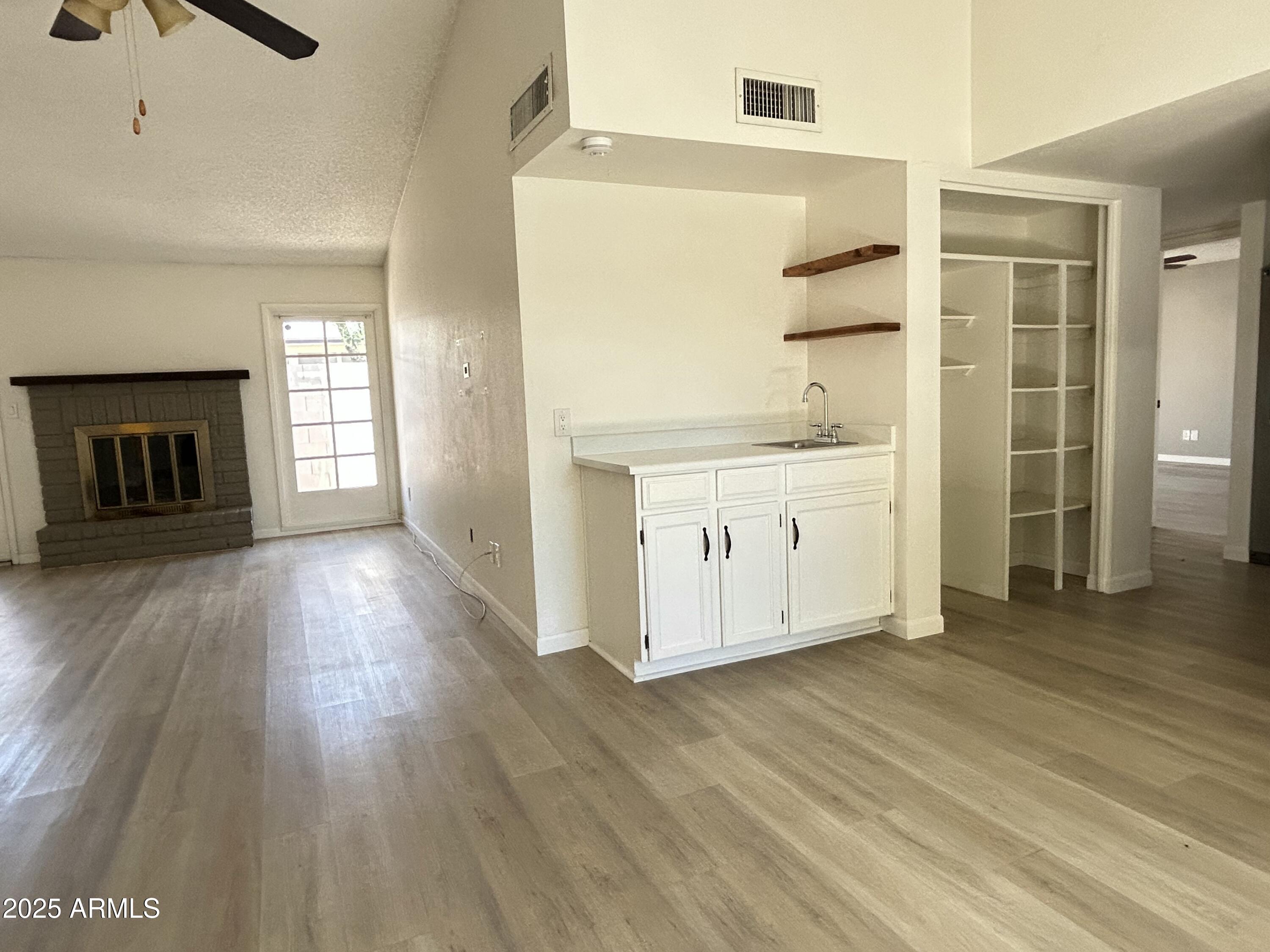 17838 North 45th Avenue Glendale, AZ 85308 - Photo 8 of 17 a view of a kitchen with wooden floor and a ceiling fan