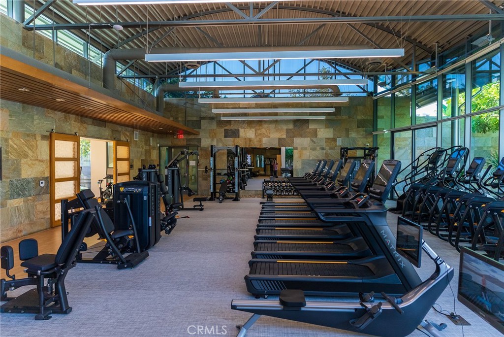 21 Gramercy, Unit 102 Irvine, CA 92612 - Photo 25 of 30 Modern resident gym with premium equipment for a complete at home fitness experience.