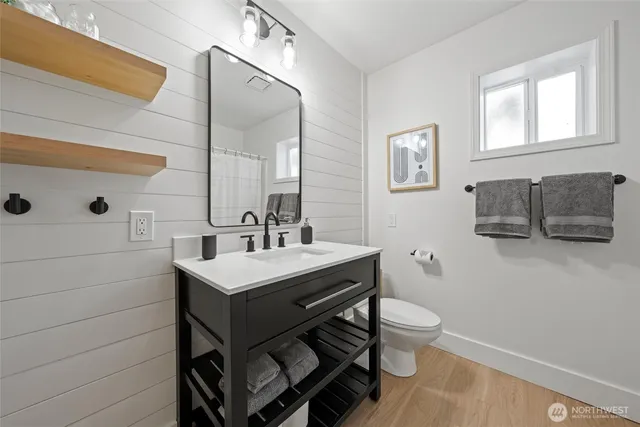 a bathroom with a sink toilet and mirror