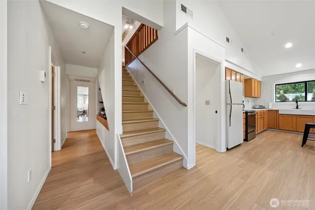 a view of a hallway view with wooden floor and staircase