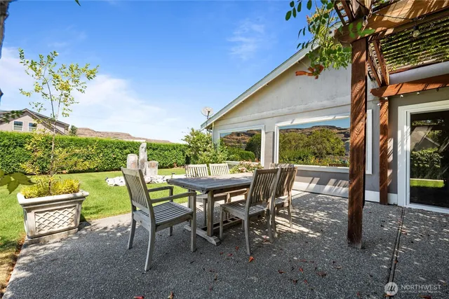 a view of a patio with table and chairs and potted plants