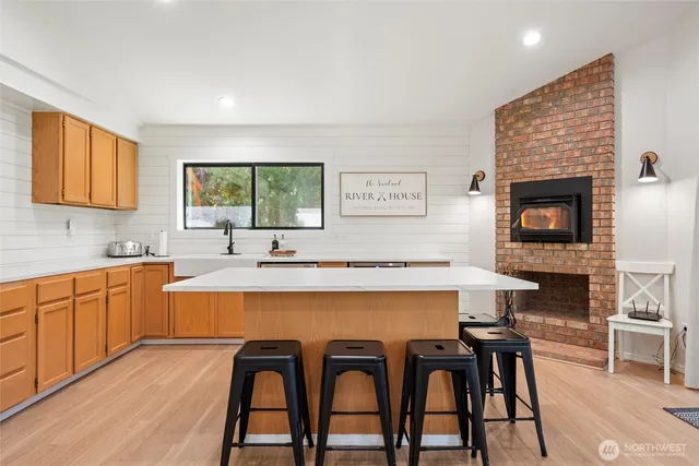 a kitchen with a table chairs sink and cabinets