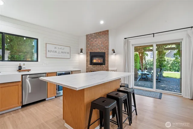 a open kitchen with stainless steel appliances granite countertop a stove top oven a sink and a refrigerator