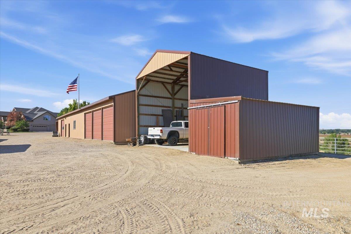 20337 Maggard Lane Caldwell, ID 83607 - Photo 39 of 50 This is opposite view of additional storage, 24T hay storage, 3-bay equipment shed with roll-up doors, bunkhouse, shop, and craft studio.