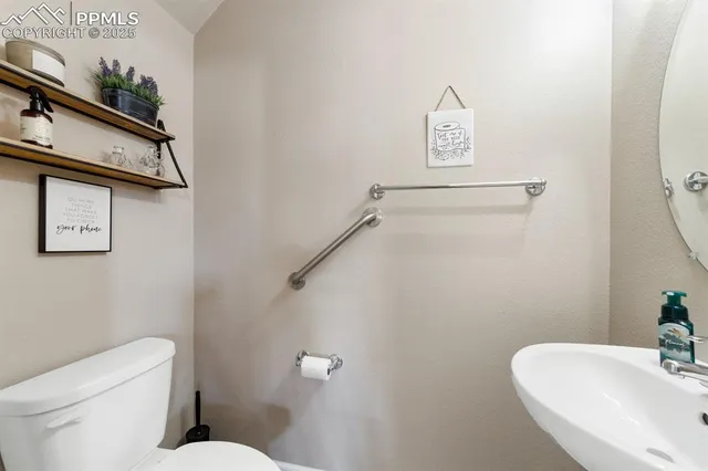 a white toilet sitting next to a bathroom sink