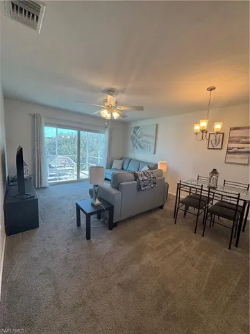 a spacious bedroom with a bed and a tv