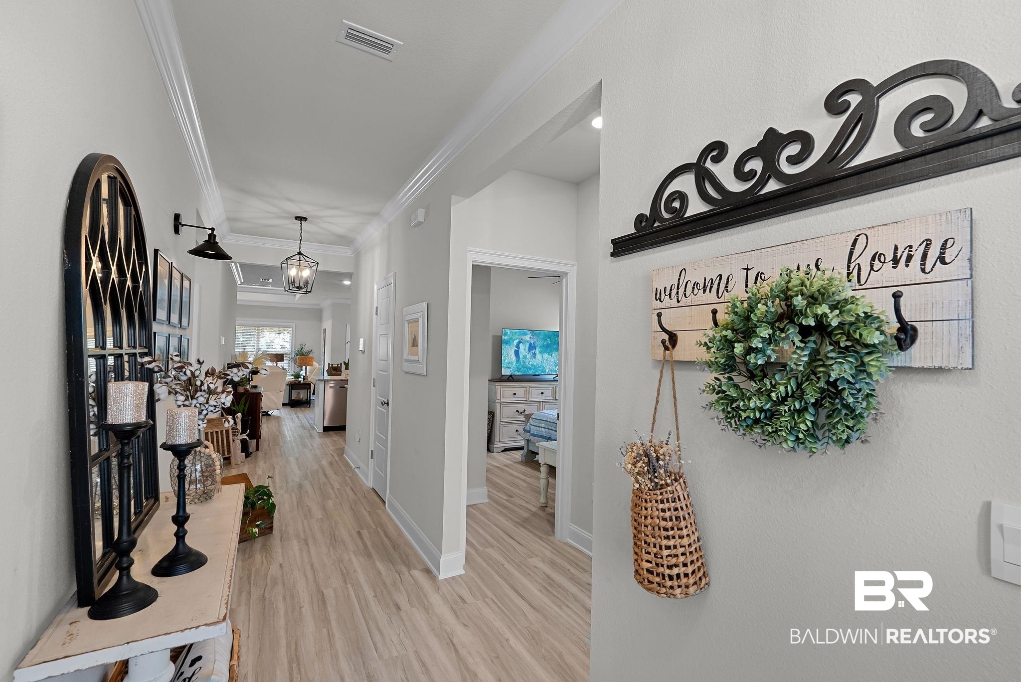 13966 Antler Hl Road Daphne, AL 36527 - Photo 3 of 44 Hallway featuring wood-finish flooring and crown molding