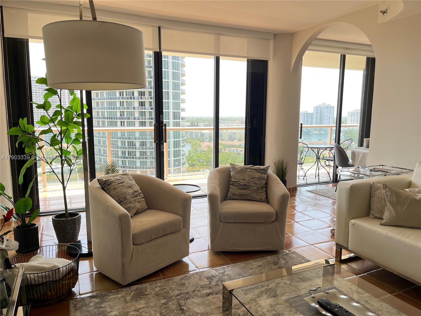 4000 Island Boulevard, Unit 1703 Aventura, FL 33160 - Photo 15 of 29 a living room with furniture and a large window