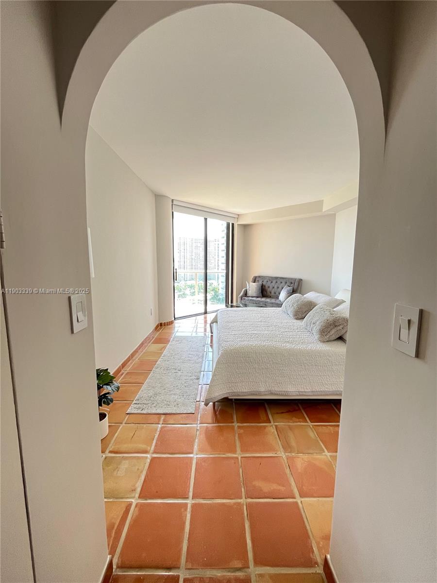 4000 Island Boulevard, Unit 1703 Aventura, FL 33160 - Photo 24 of 29 a room with a rug and white walls