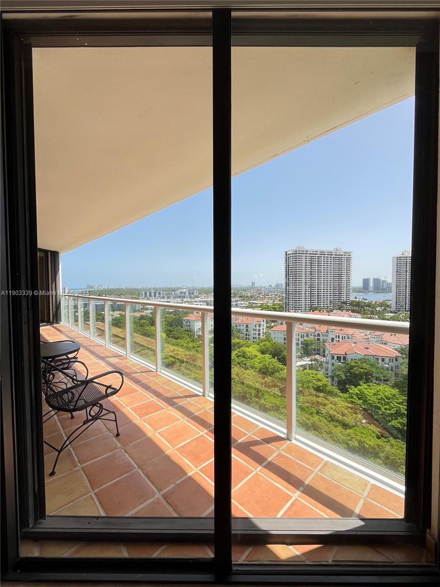 4000 Island Boulevard, Unit 1703 Aventura, FL 33160 - Photo 26 of 29 a view of a living room and floor to ceiling window