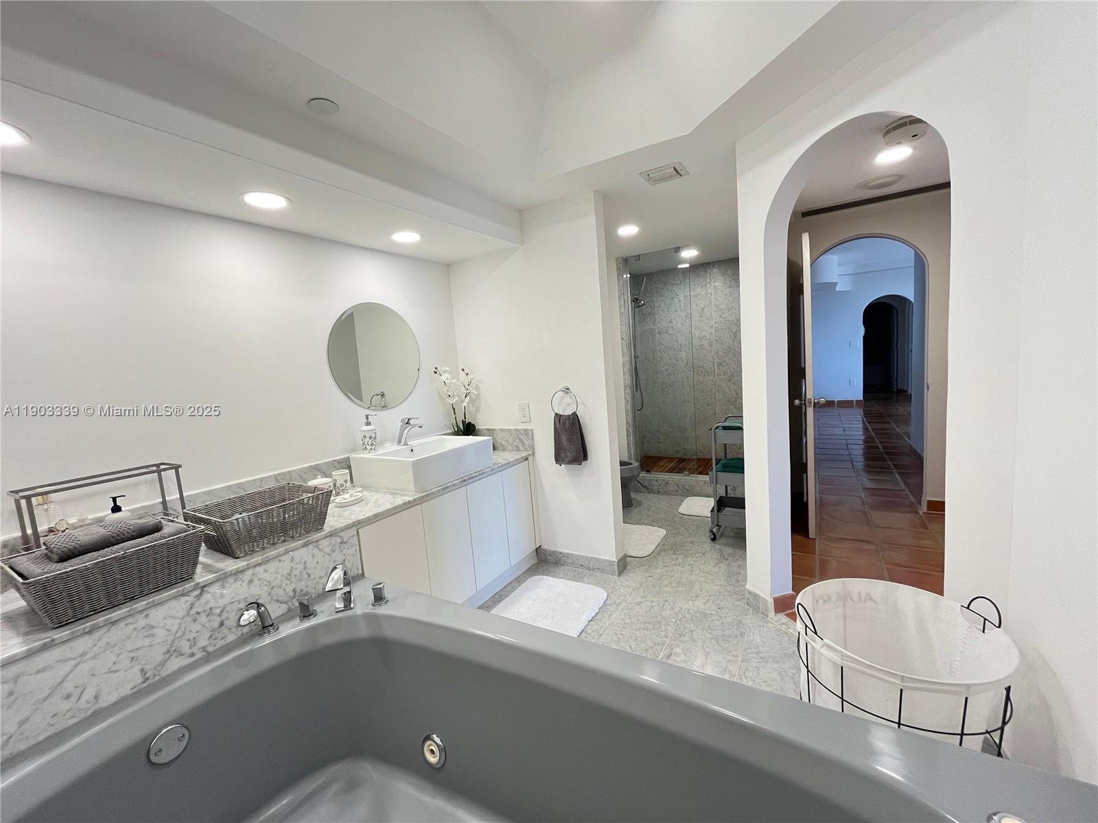 4000 Island Boulevard, Unit 1703 Aventura, FL 33160 - Photo 28 of 29 a bathroom with a double vanity sink mirror and bathtub