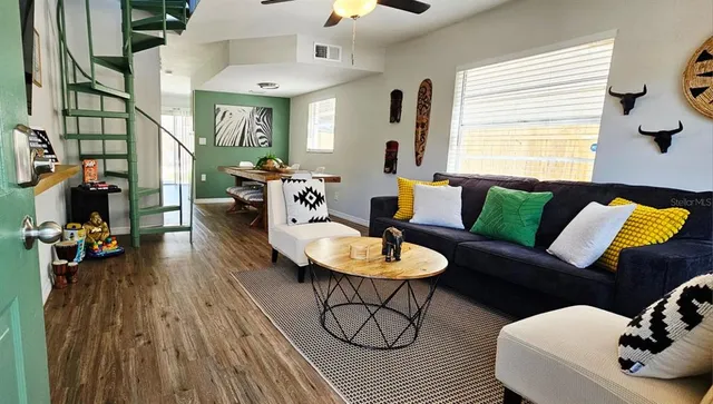 a living room with furniture and wooden floor