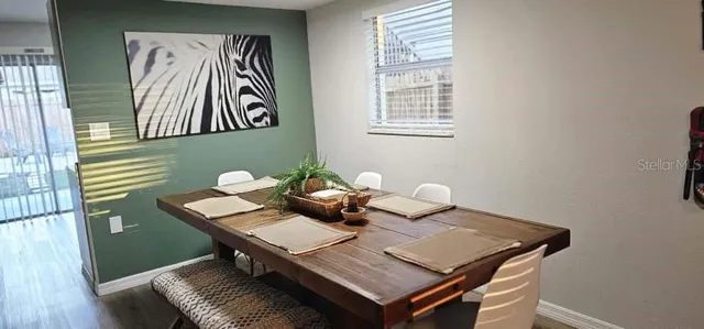 a view of a dining room with furniture and wooden floor
