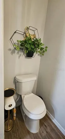 a white toilet sitting next to a shower