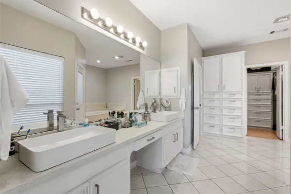a bathroom with a sink double vanity and a shower