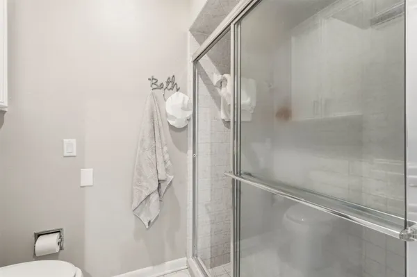 a bathroom with a glass shower door
