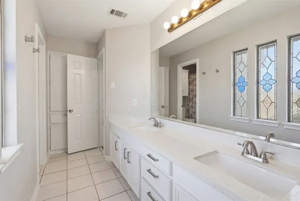 a bathroom with a double vanity sink mirror and double