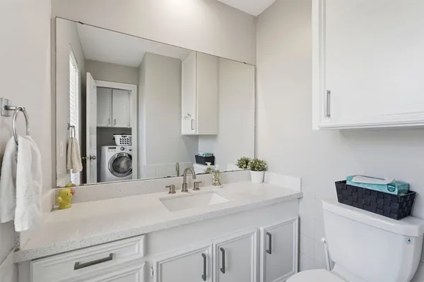 a bathroom with a sink toilet and vanity