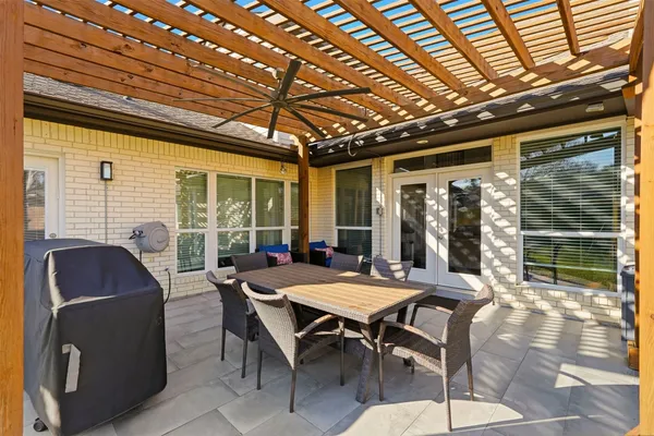 a view of a patio with a table and chairs