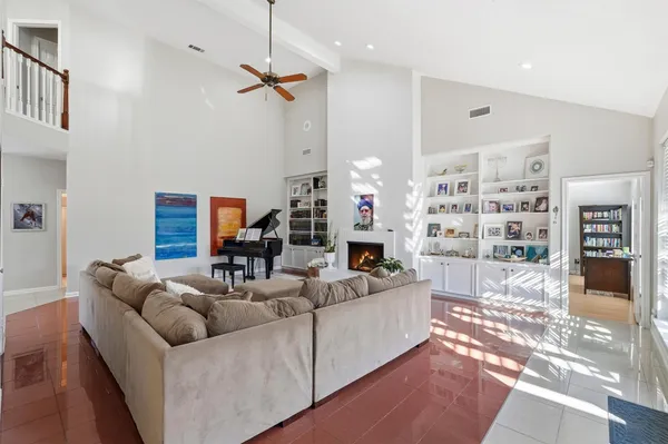 a living room with furniture and a book shelf