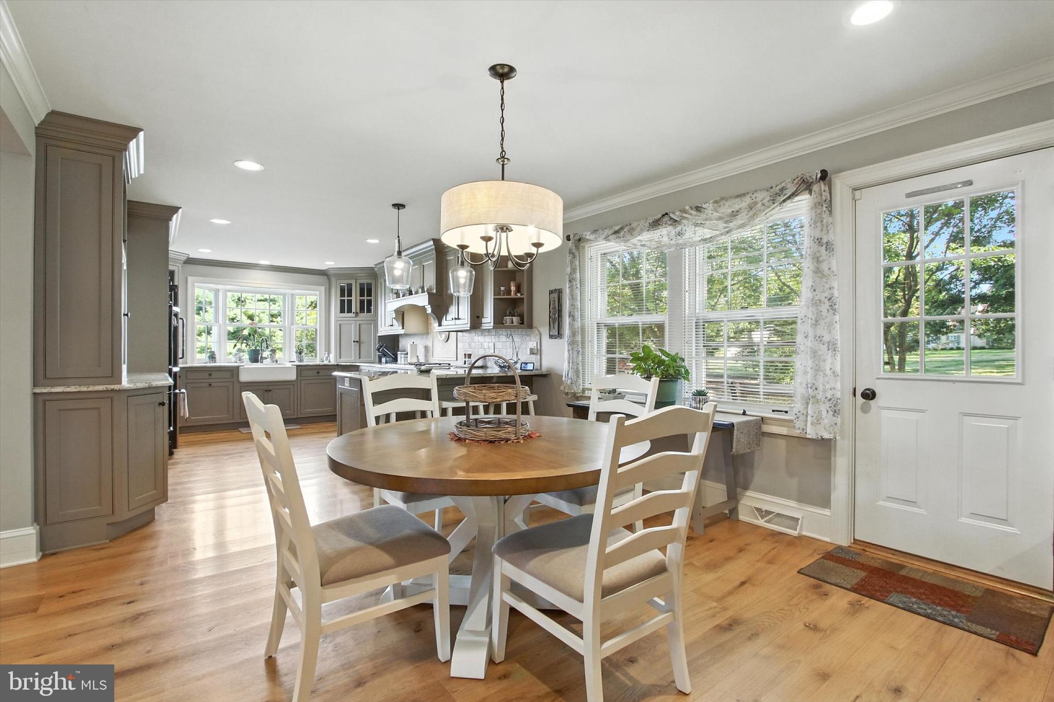 830 Westminster Avenue Hanover, PA 17331 - Photo 25 of 43 a dining room with wooden floor a chandelier a glass table and chairs
