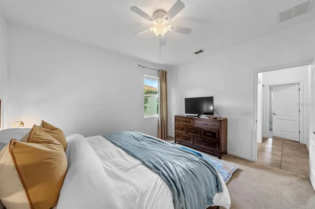a bedroom with two beds and painting on the wall