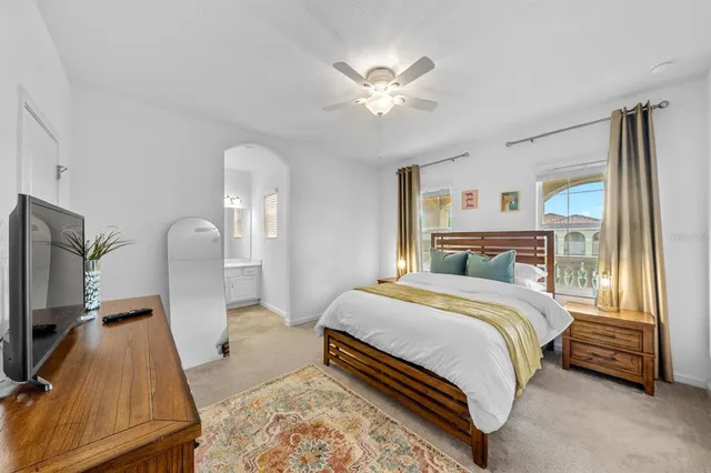 a living room with a table chairs and a chandelier