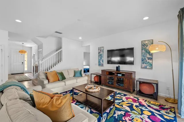 a dining room with kitchen island furniture a chandelier and kitchen view