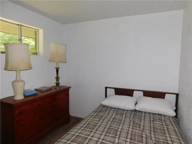 a bedroom with a bed and a lamp on table