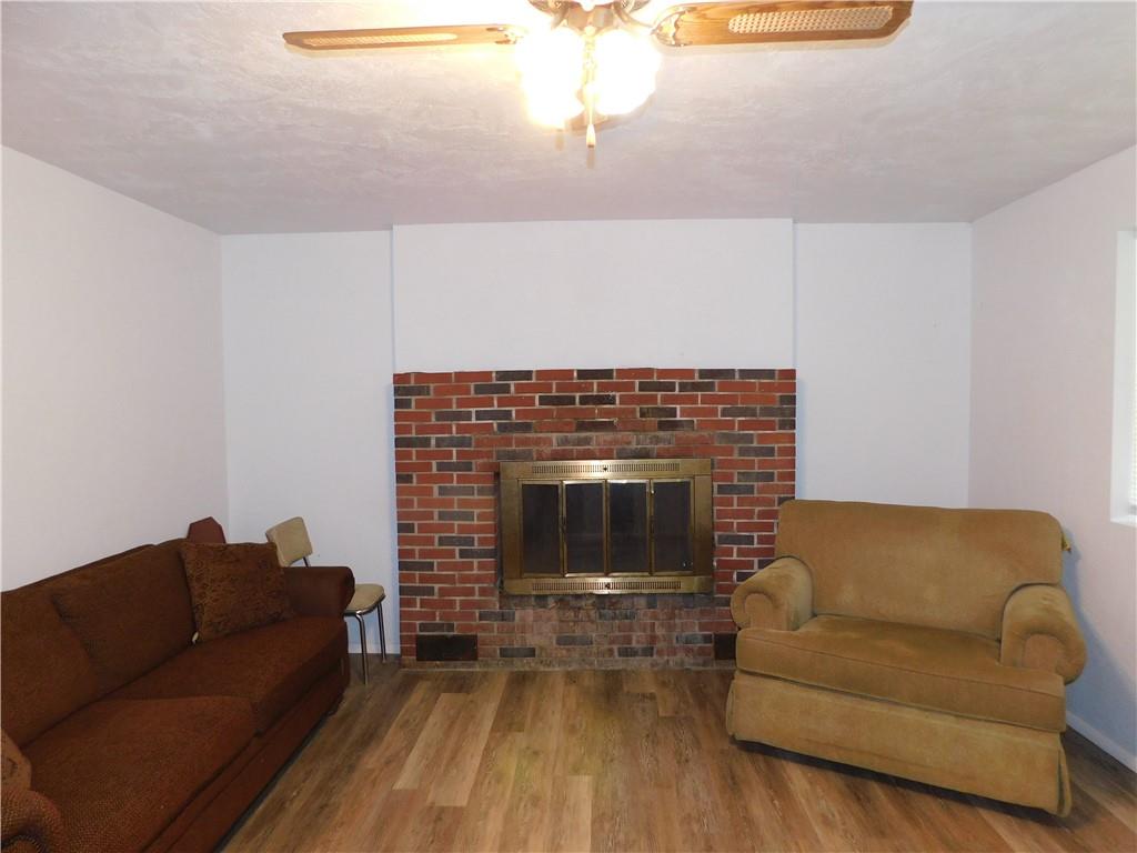 367 Pike School Road Markleysburg, PA 15459 - Photo 8 of 16 a living room with furniture and a fireplace