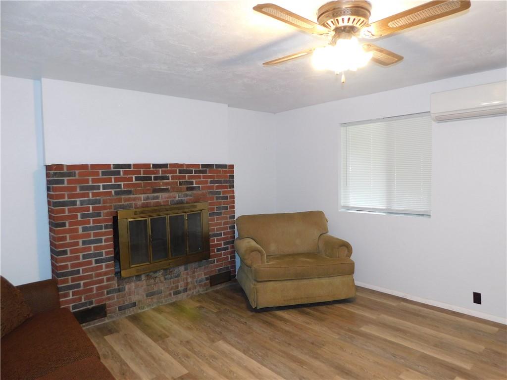 367 Pike School Road Markleysburg, PA 15459 - Photo 9 of 16 a living room with furniture and a fireplace